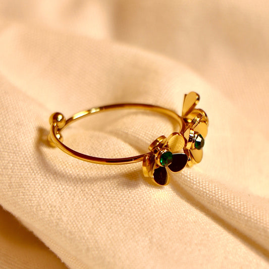 The delicate gold bracelet with flower charms and a green gemstone pairs perfectly with Vellura Jewellery’s Gold Floral Adjustable Ring with Green Gemstone for a coordinated floral look.