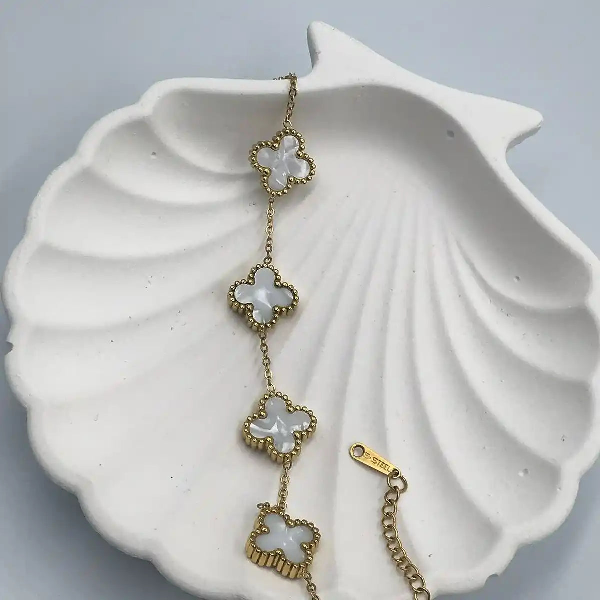 Van Cleef & Arpels luxury bracelet featuring iconic Alhambra design in yellow gold with mother-of-pearl motifs