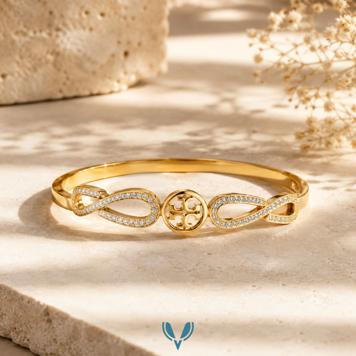 Gold infinity motif crystal bangle in sunlight